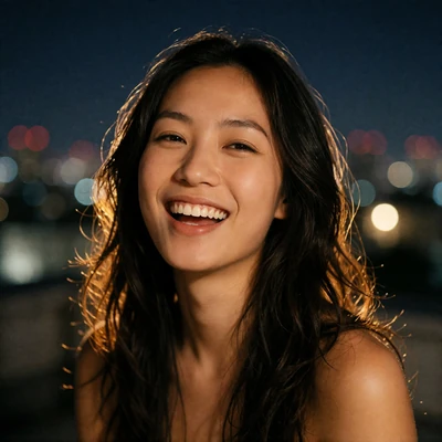 Asian woman laughing softly with a night skyline blurred behind her